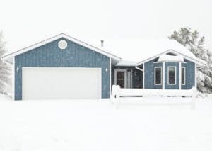 House with a garage in a winter storm