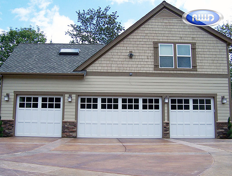 Home with 3 white Garage doors