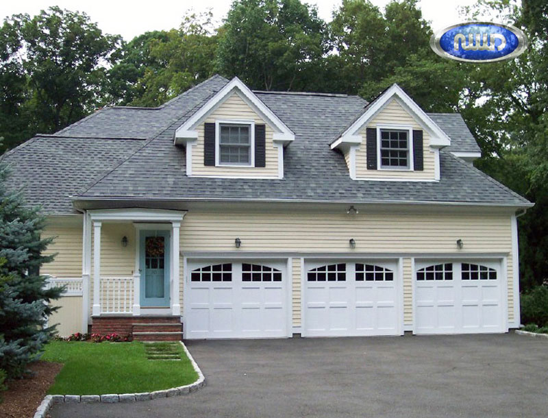 Home with 3 white garage doors