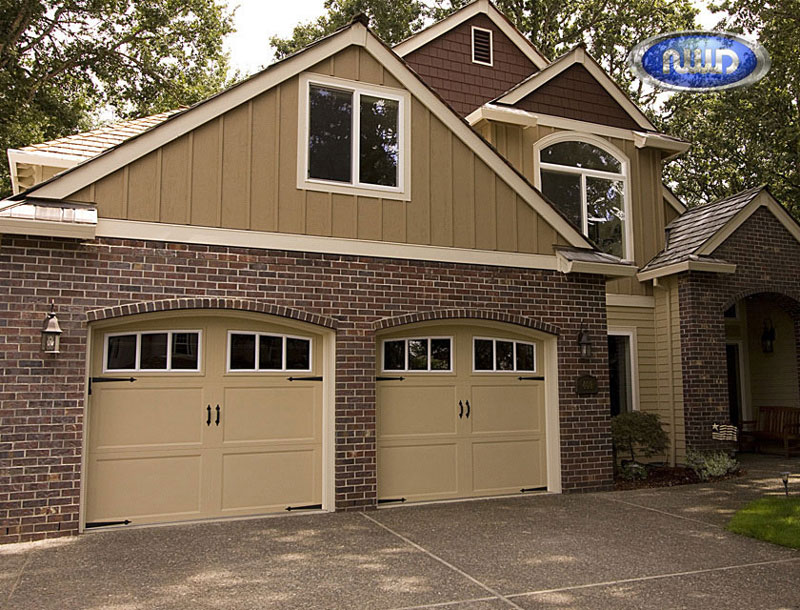 Brick Home with 2 Cream colored garage doors