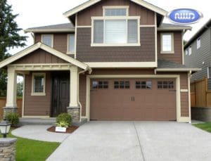 House with a brown single Garage door