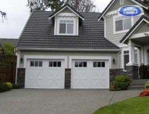Beautifil home with 2 white garage doors